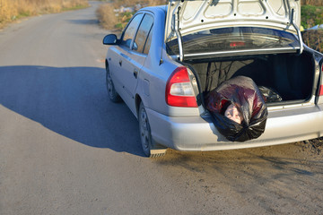 The corpse of a girl in a car trunk