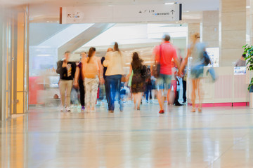 Abstract defocused motion blurred people, walking couple in the shopping center, urban lifestyle...