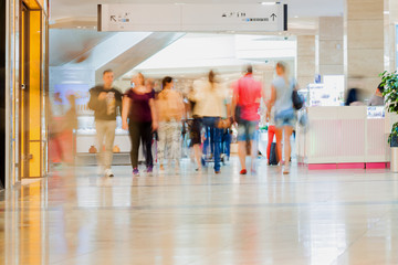 Abstract defocused motion blurred people, walking couple in the shopping center, urban lifestyle concept, background.