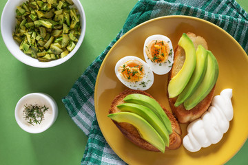 Sandwiches with avocado, eggs and sauce
