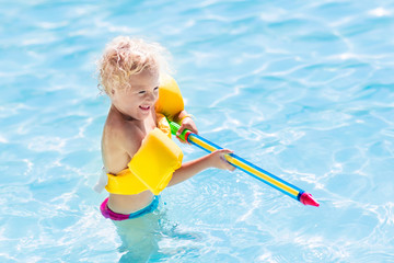 Child playing in swimming pool