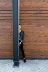 girl in front of wood wall