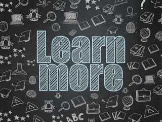 Fototapeta na wymiar Learning concept: Learn More on School board background
