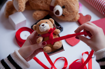white caucasian hands wrapping teddy bear on the wonderful things for decoration background