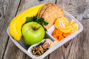 Health and Fitness food in lunch box on wooden background