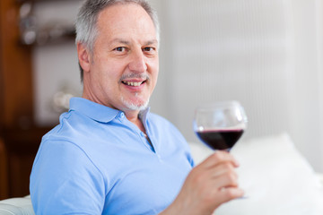 Man holding a glass of red wine