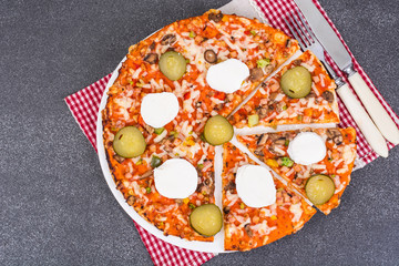 Home pizza with mozzarella and pickled gherkins