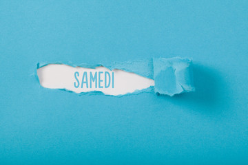 Samedi (French Saturday) weekday message on Paper torn ripped opening