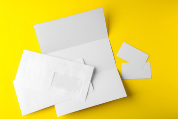 Blank brochure, envelope and card on yellow background