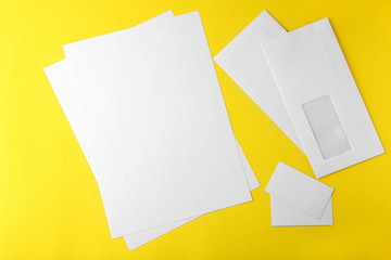 Blank brochure, envelope and card on yellow background