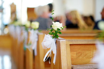 Naklejka na ściany i meble Beautiful flower wedding decoration in a church during wedding ceremony