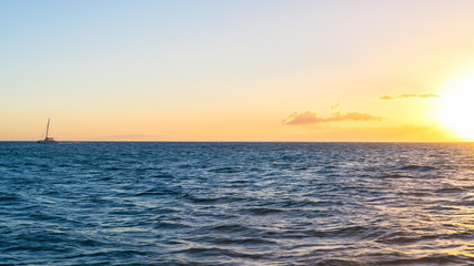 Sailboat sailing over the sea at sunset