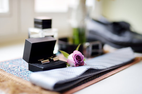 Groom's wedding accessories: tie and two golden cuff links in black box