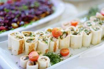 Delicious pork rolls with vegetables served on a party or wedding reception