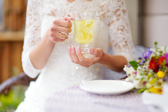 Woman In White Dress Drinking Hot Ginger Tea