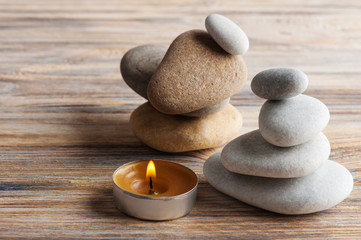 Obraz na płótnie Canvas zen composition with stones and lit candle