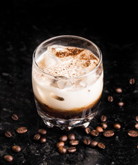 White russian with coffee beans on a table