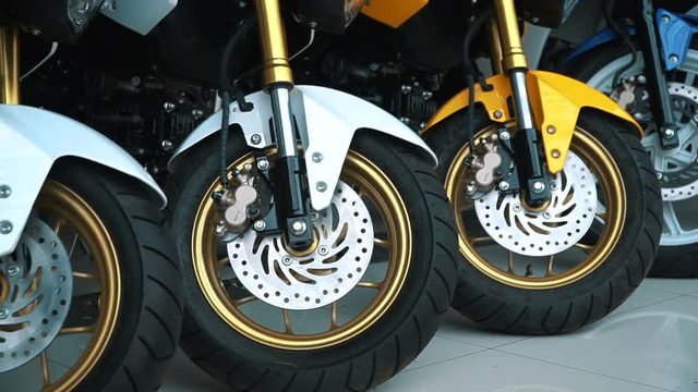 Low angle shot of a custom motorcycle wheels at the store. Pan video.
