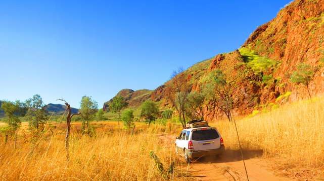 Outback australia - driving 4x4 4 wheel drive jeep off road through dirt track to camping spot near Lake Argyle