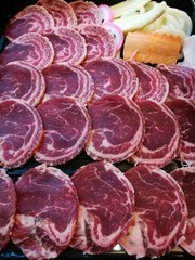 Fresh beef slice serving on the tray with some vegetable, carrot corn and cabbage,