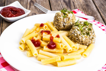 Pasta with meatballs and ketchup for lunch