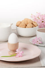 Fototapeta na wymiar Hyacinth Flowers. Amaretti Biscuits. Boiled Egg. Cup Of Tea