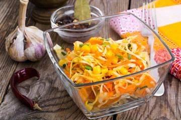 Vegetable salad with corn in a glass salad bowl