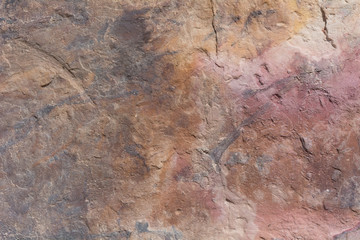 Textured surface of colorful rock