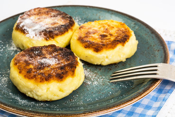 Curd cheese pancakes on the plate on white background
