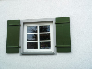 Green wooden window shutters