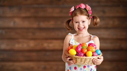 Happy child girl  with basket of easter eggs