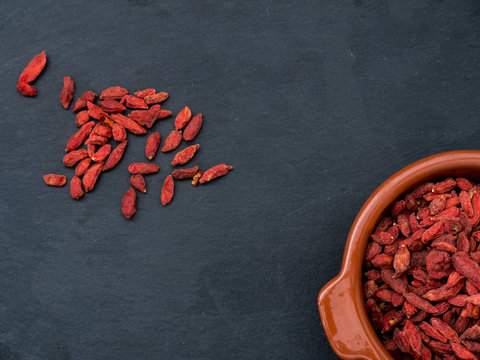 Goji Berries in a small bowl on a slate tablet
