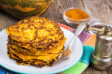 Pumpkin Pancake on plate on background of old wooden planks