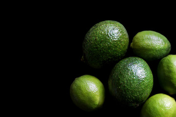 avocado and limes on a black background