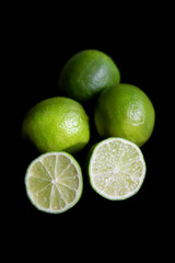 juicy limes on a black background