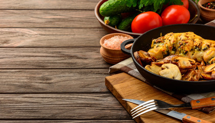 Baked chicken breast stuffed with spinach and cheese with vegetables on a dark background of a wooden table. Copy space.