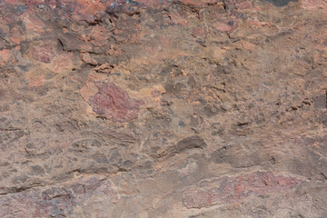 Textured surface of colorful rock