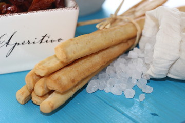 italian food, italian cuisine, italian starter, grissini with salt, dried tomatos