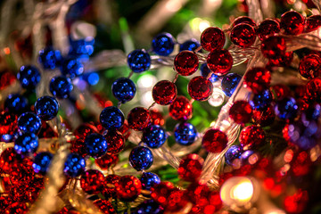 Abstract, blurry, vibrant and colorful background. A shot of Christmas decorations and lights on a lit Christmas Tree. Celebrations, holidays, family together, warmth in hearts. Champagne and lights.
