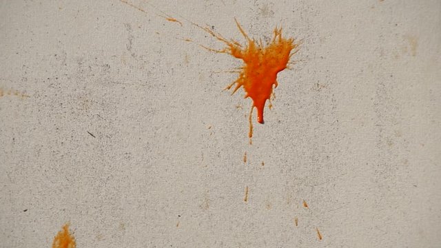 Throwing balls with paint on the wall
