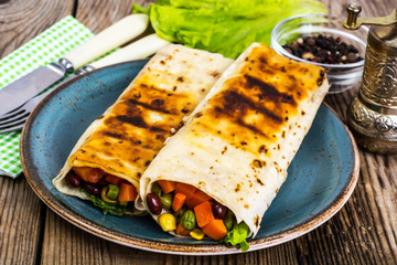 Tortilla with vegetable mix on blue plate