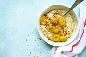 Oat porridge with caramelized banana and cinnamon .Top view with copy space.