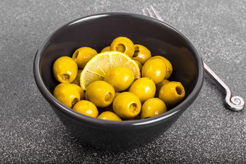 Green olives in salad bowl black