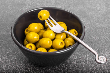 Green olives in salad bowl black