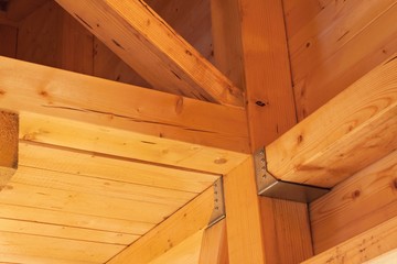 Wooden beams on the construction of ecological buildings. Construction site timber construction.