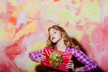Fototapeta premium Pretty girl with red gift box with golden bow