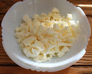 Cheese white sliced ​​for salad on a white plate