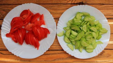 
Tomato and cucumber fresh sliced ​​on a white plate