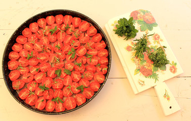 Cherry tomatoes with herbs and spices prepared for dried tomatoes