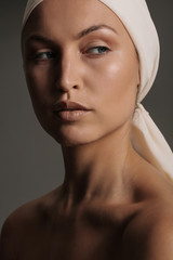 Fototapeta premium Female model with natural makeup and head scarf